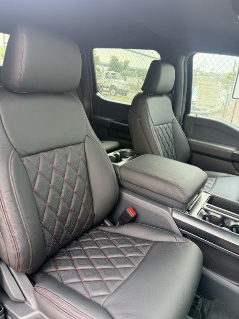 Black leather seats with red diamond stitching