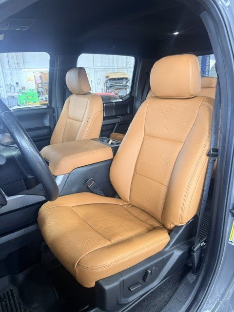 Saddle tan leather seats in a Ford truck