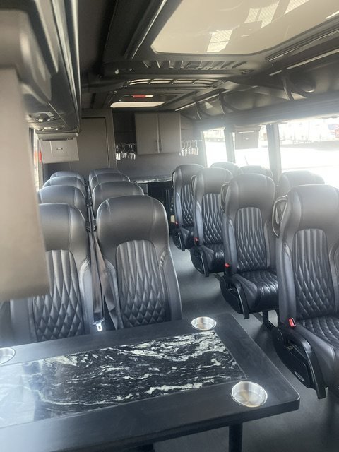 Leather seating and tables in the Nemacolin Resort luxury bus