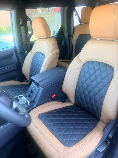 Ford Bronco front seats in saddle tan leather with black diamond inserts