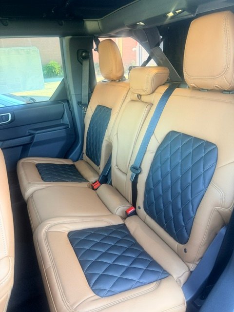 Ford Bronco rear seats in saddle tan leather with black diamond inserts
